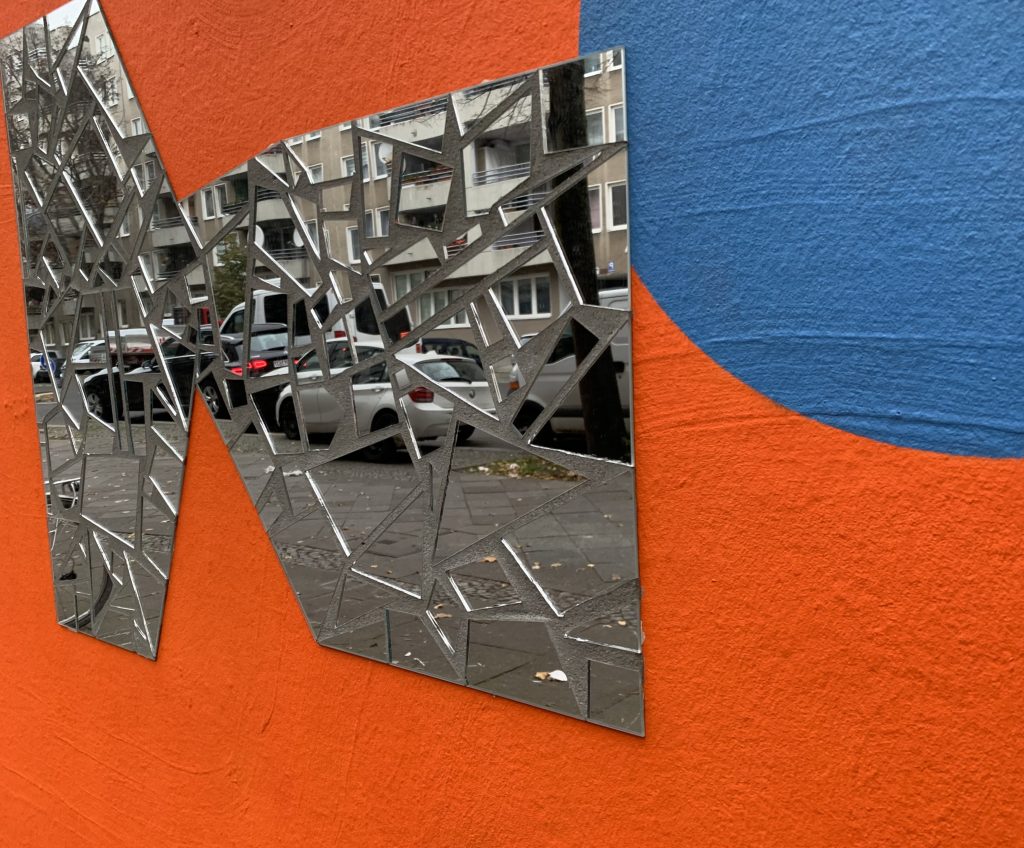 Reflecting object on a orange and blue wall