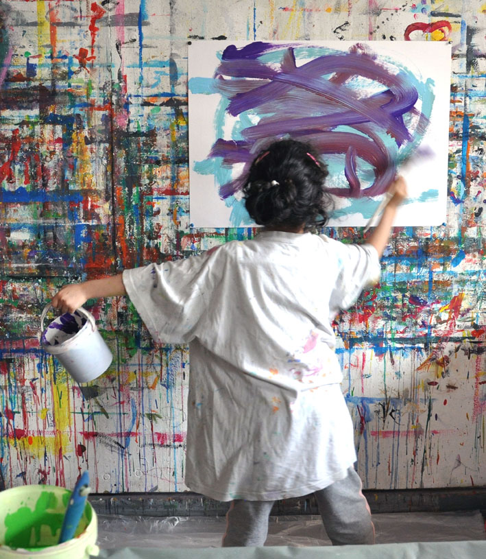 Child viewed from the back painting