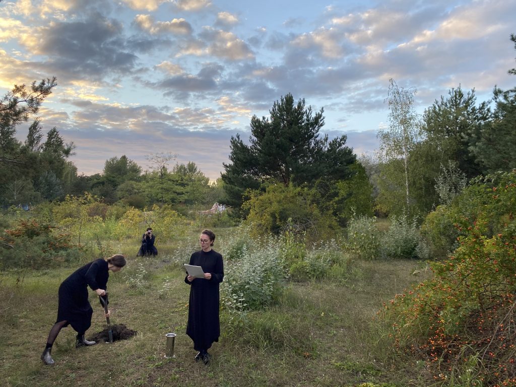 Three woman in black in natural landscape