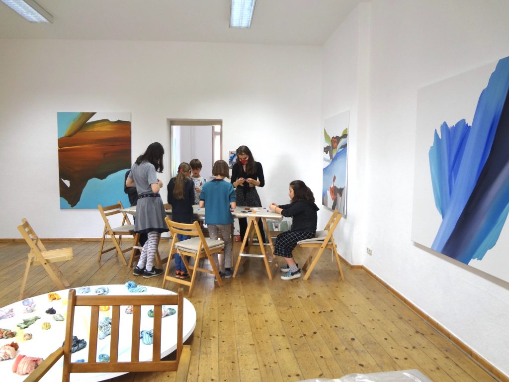 Children standing around tables crafting